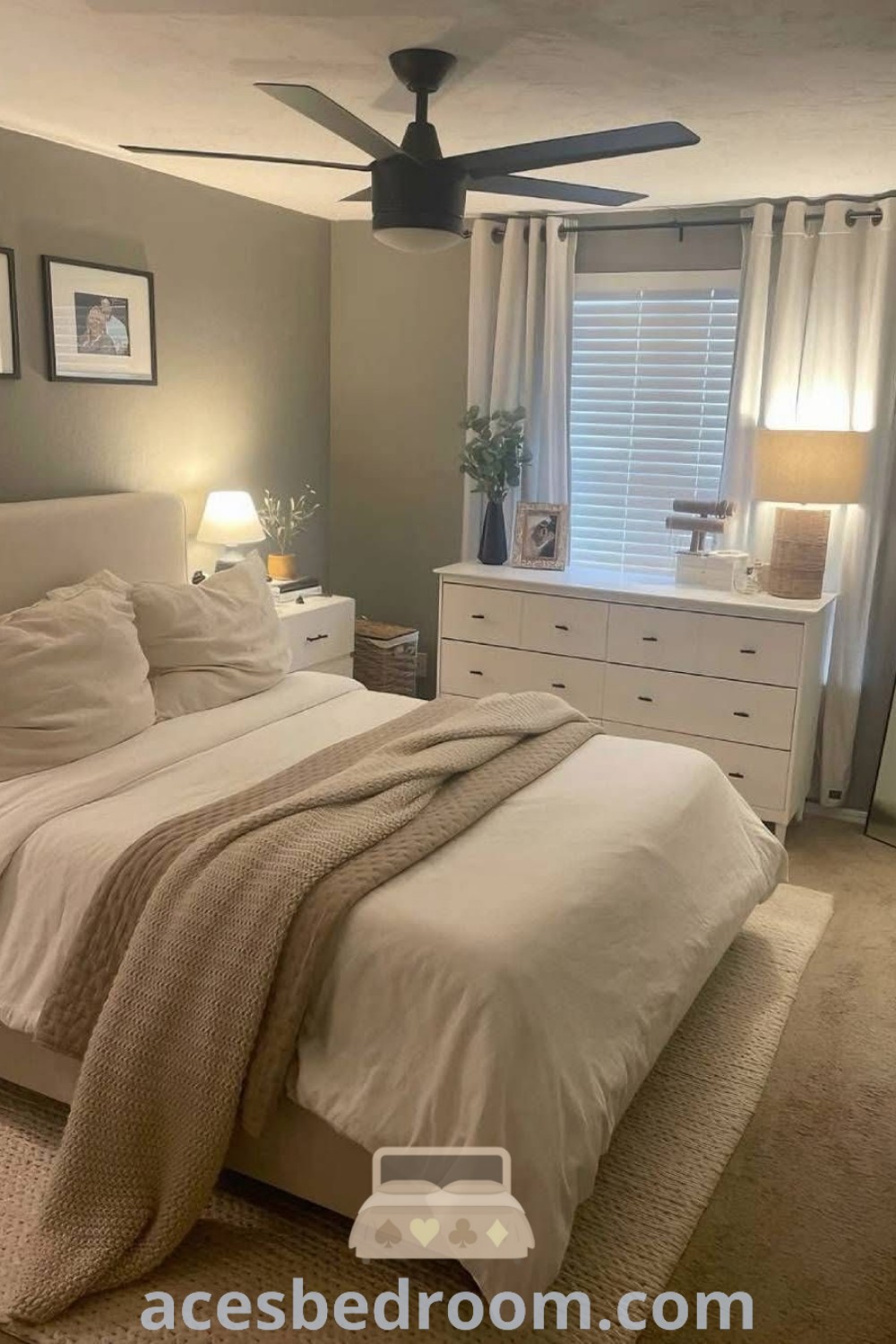 A cozy and inviting bedroom with a white bed, fluffy pillows, and white curtains adorning the window. This design showcases apartment bedroom decor ideas, emphasizing a relaxing aesthetic. Explore more bedroom essentials and decor inspirations at acesbedroom.com.