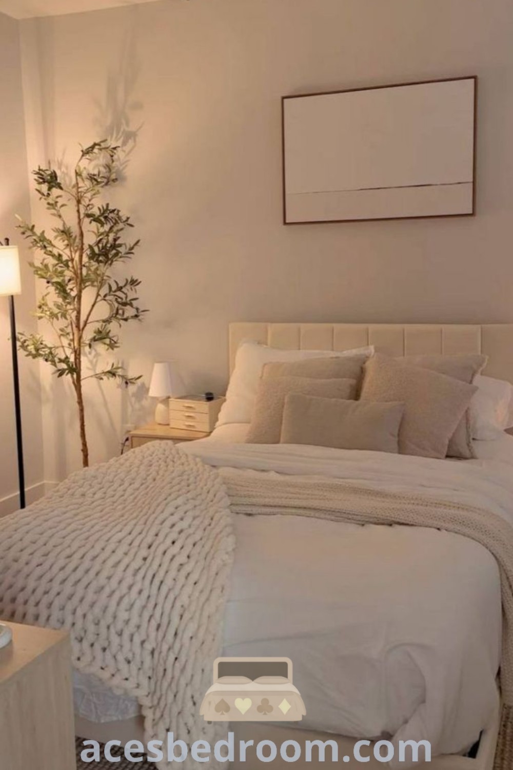 A cozy bedroom with a white bed and two lamps, showcasing beige and white decor ideas for a clean aesthetic. This inviting space illustrates stylish small bedroom ideas and neutral bedroom color schemes for a cozy home. Get more decor inspirations at acesbedroom.com.