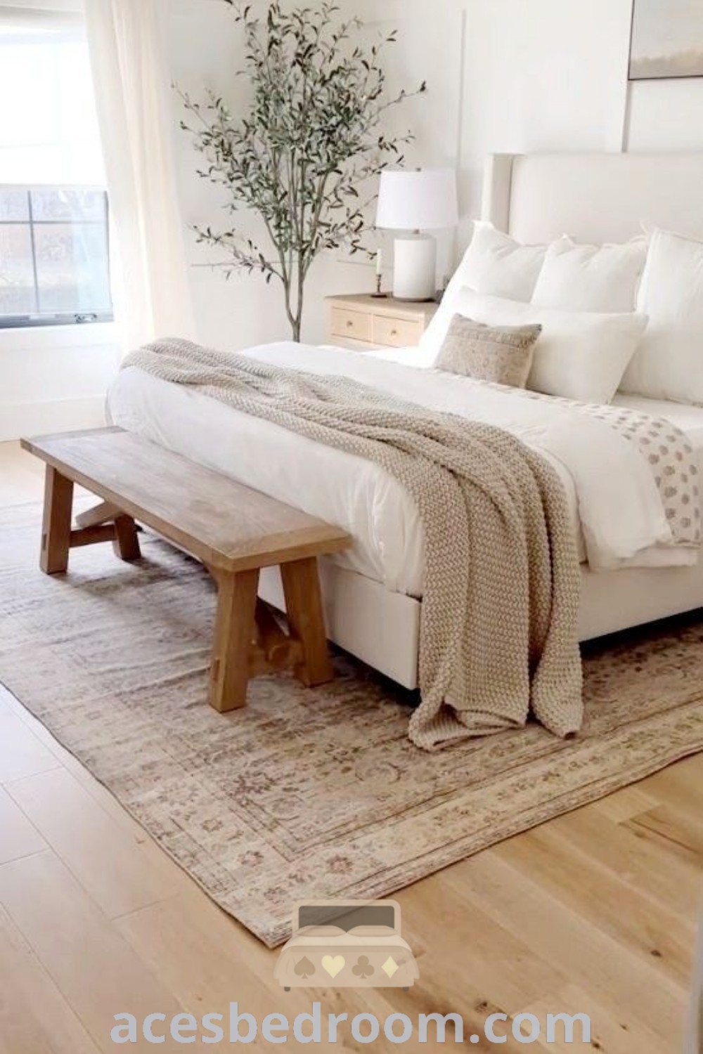 A cozy bedroom with a large bed and white walls, showcasing a warm and sophisticated look. This space offers inspiring decor ideas for a cozy home, perfect for relaxation. Explore more cozy inspirations at acesbedroom.com.